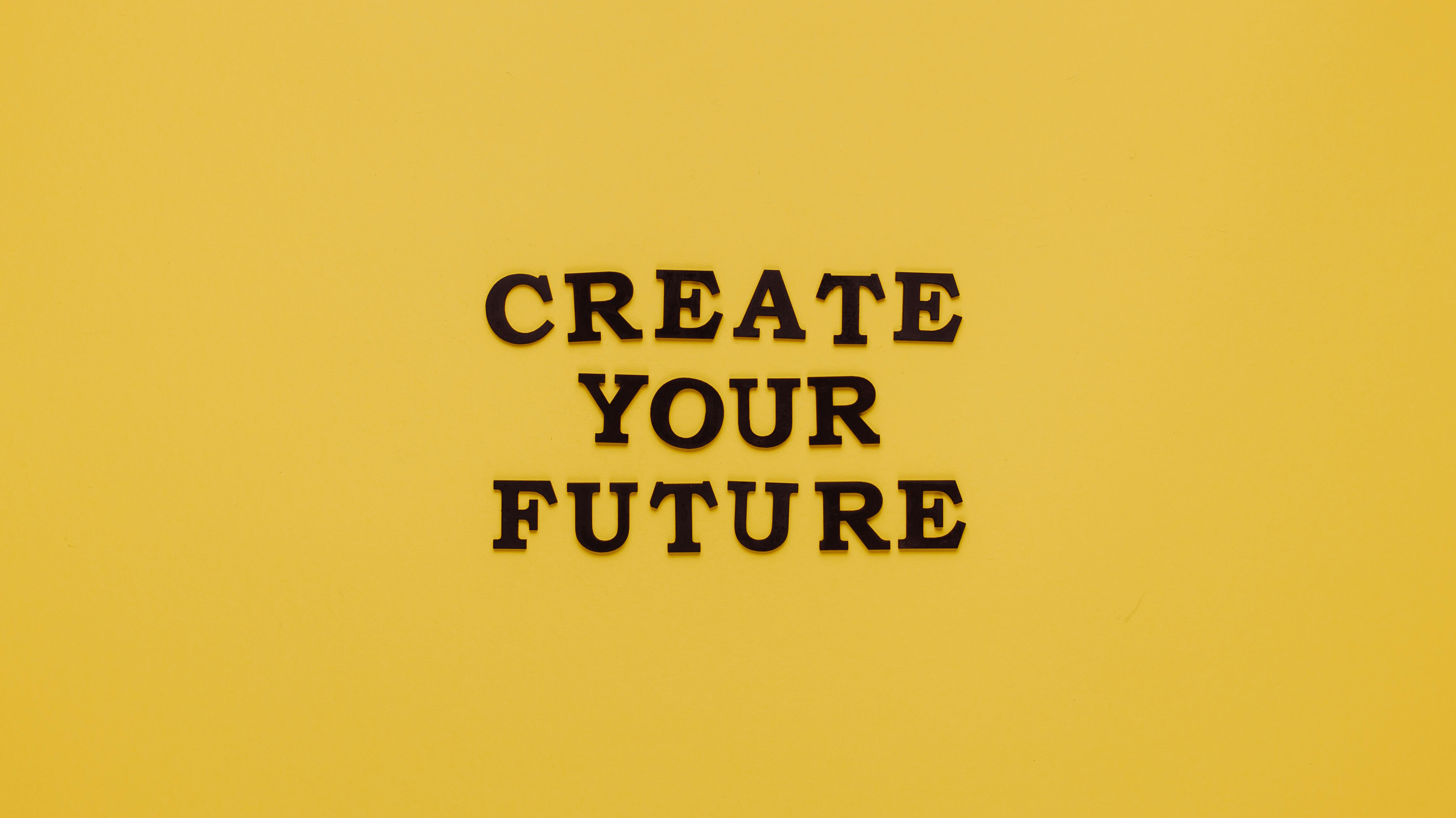 Bold text 'CREATE YOUR FUTURE' on minimalist yellow background. Inspiring design.